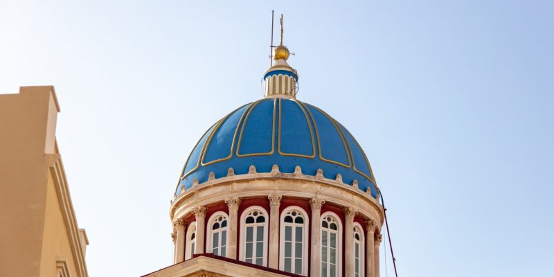 Agios Nikolaos blue color exterior dome of Greek Orthodox Church at Ermoupolis Syros island, Cyclades Greece. Under view of old neoclassical building religious destination. Protector saint for sailors